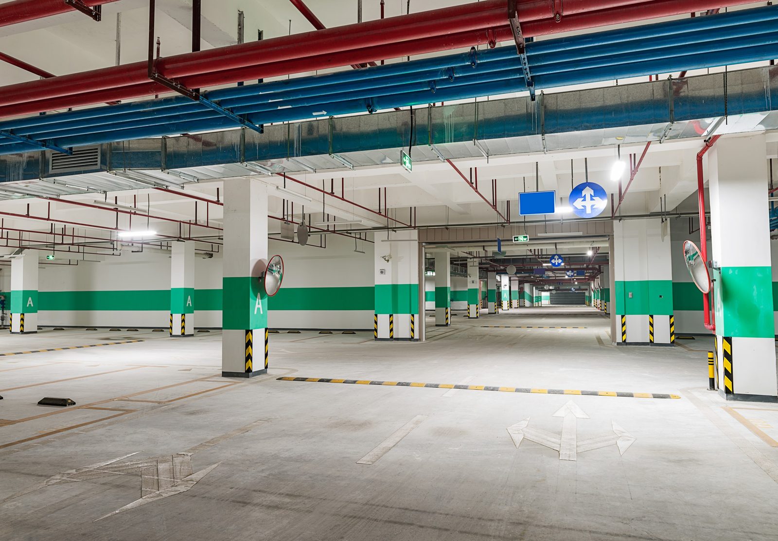 Gray coated parking structure floor with bright yellow safety markings
